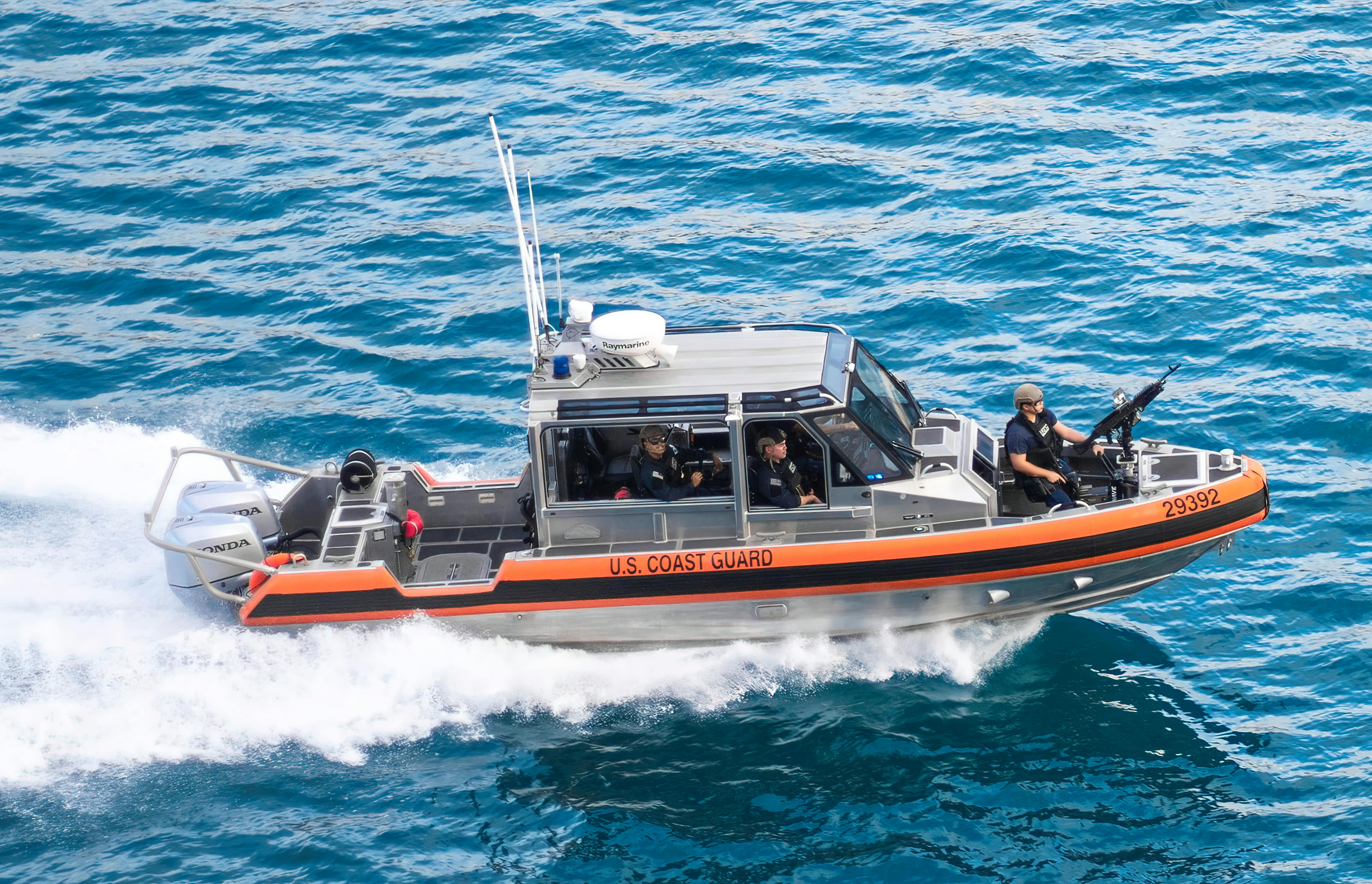 A Coast Guard ship with crewmembers.