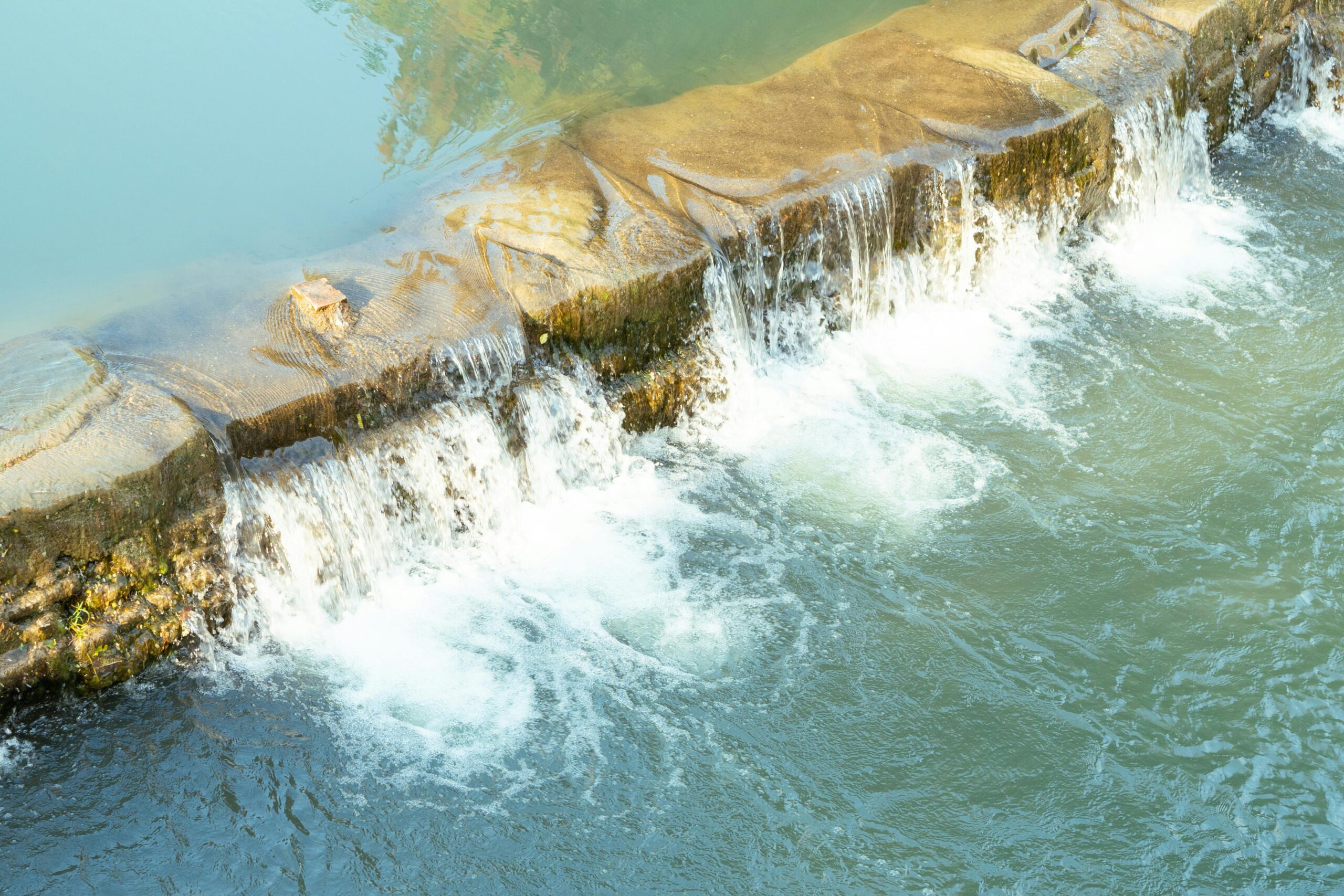 Water rolls over rocks.