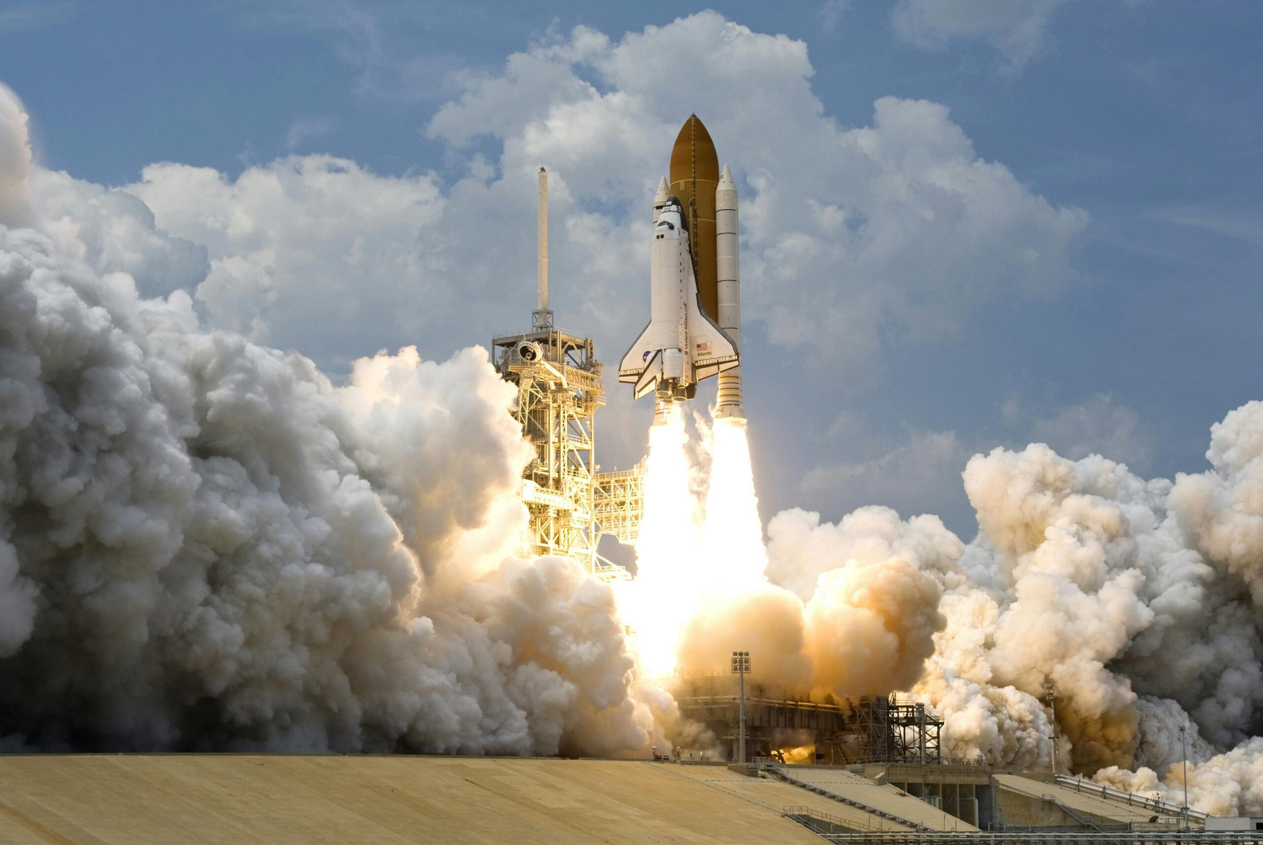 A space shuttle takes off shotting fire and rocket fuel to the ground.