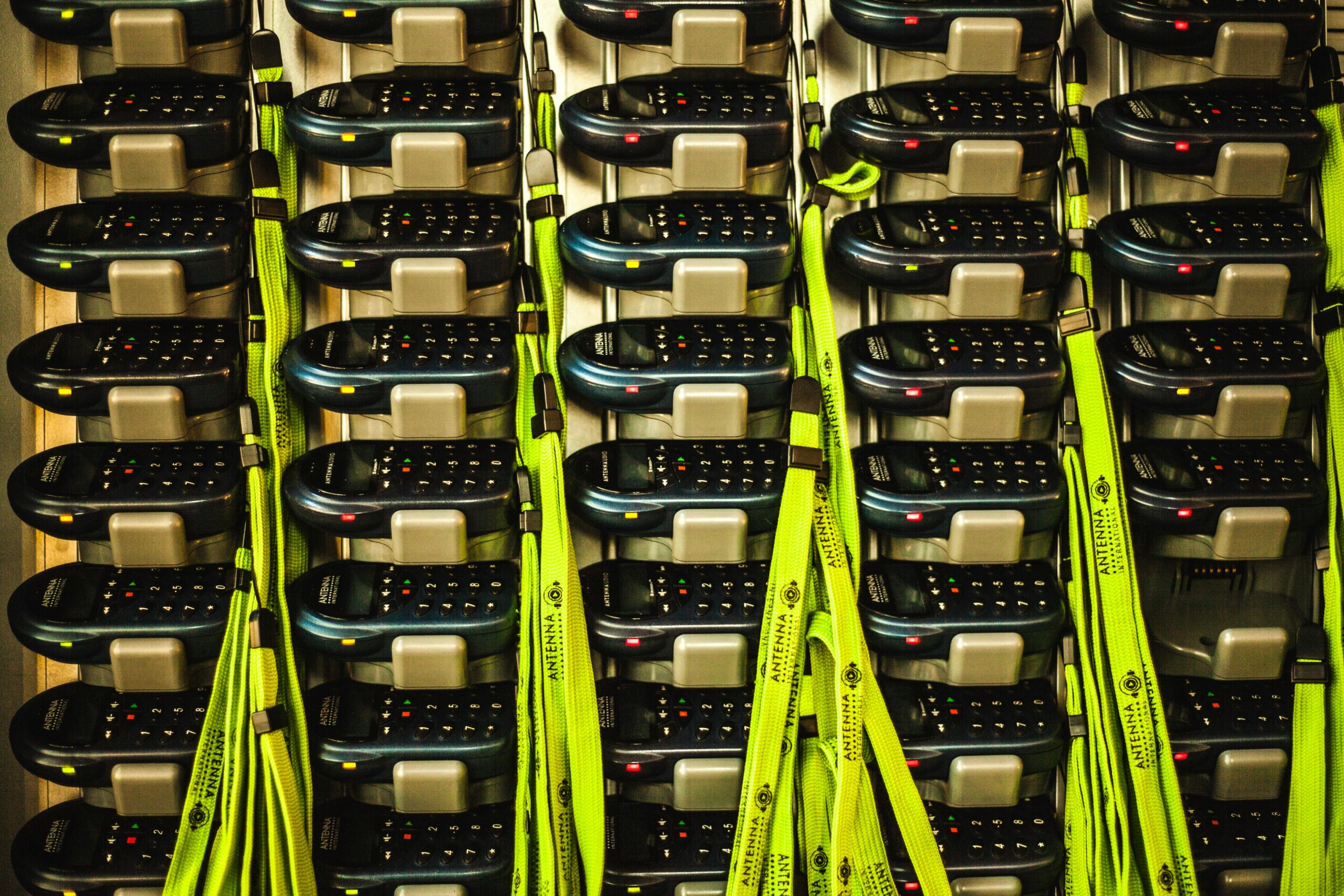 Stacks of batteries in lines and rows with green wires protruding in between.