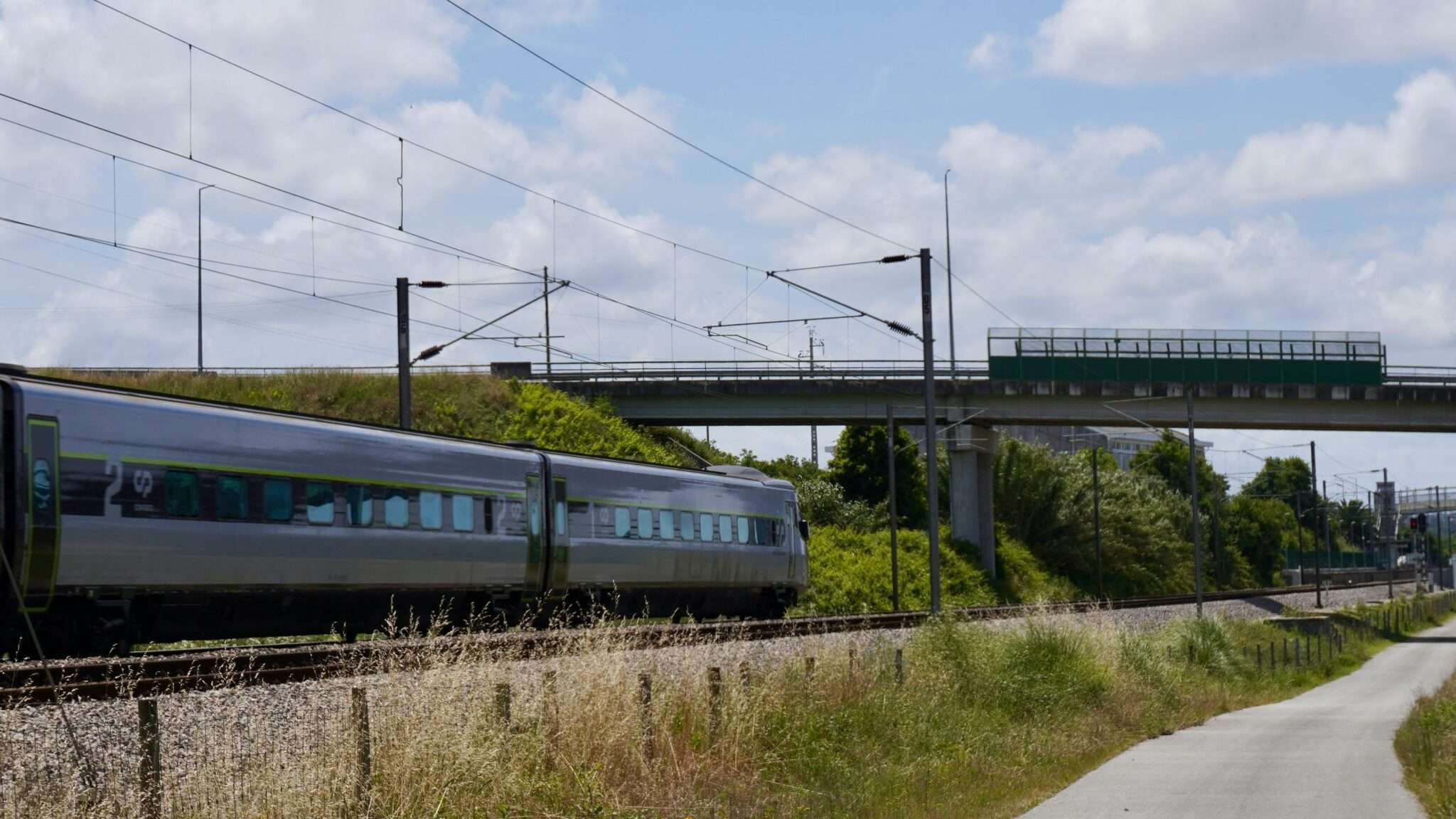 A train moves along rail road tracks in California.