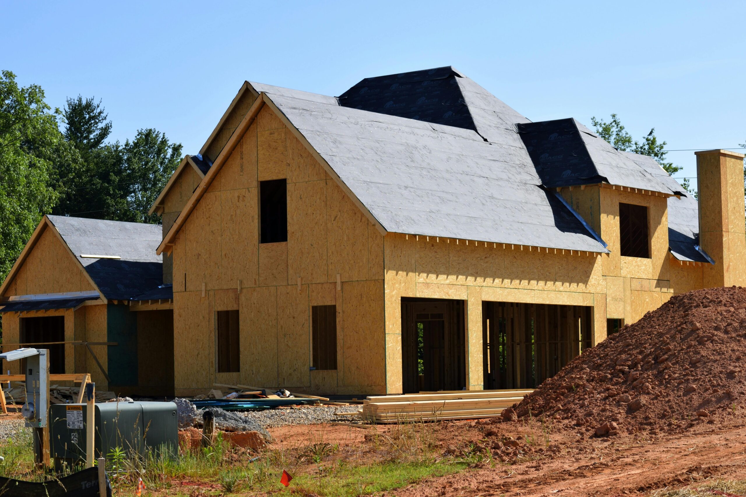 A housing development before trees and other houses.