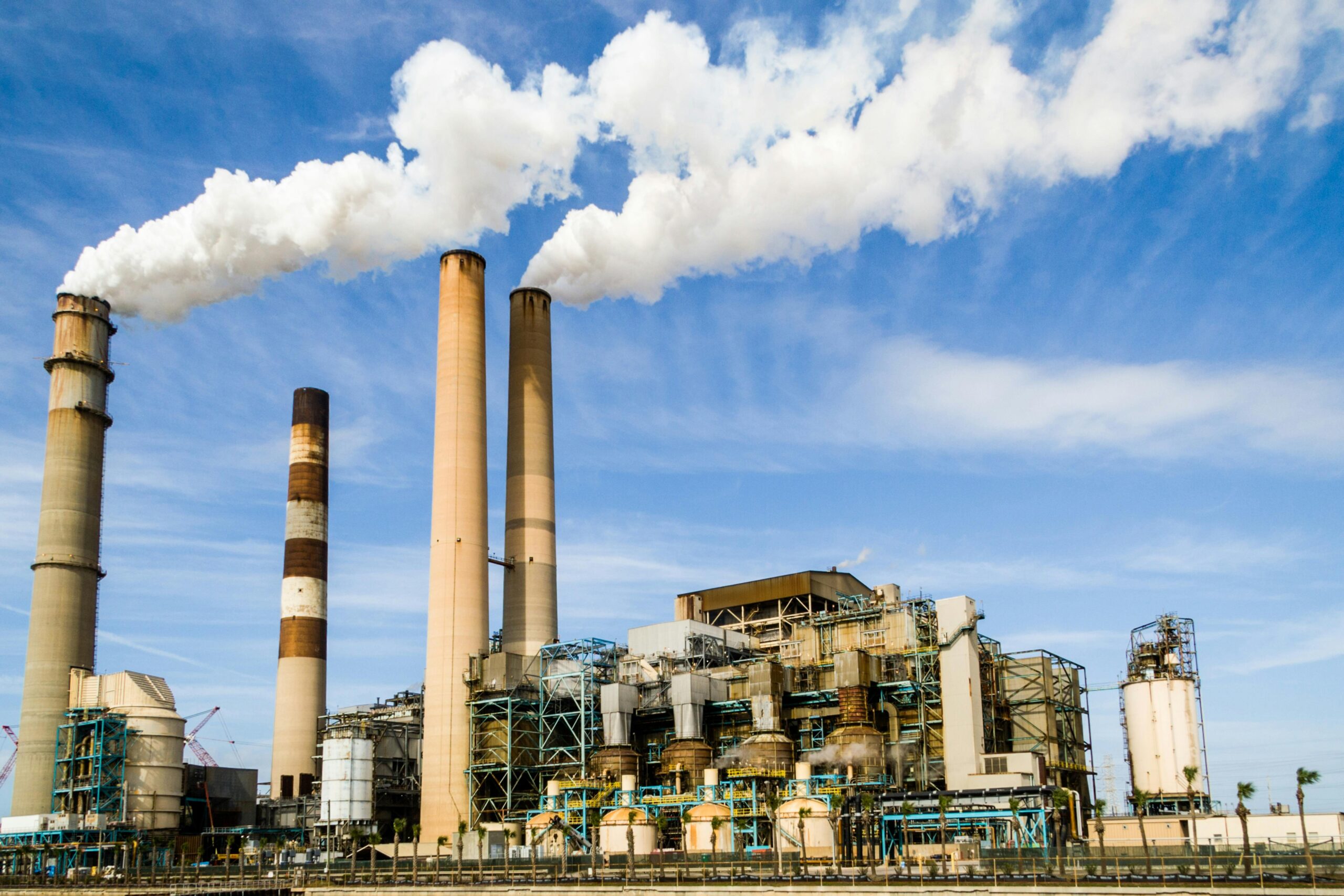 A electric-generating power plant emitting carbon into the air.