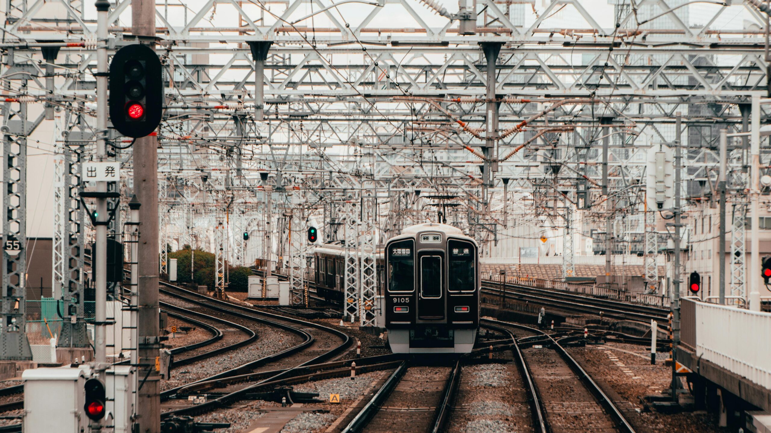 A rail corridor with a train on the tracks.