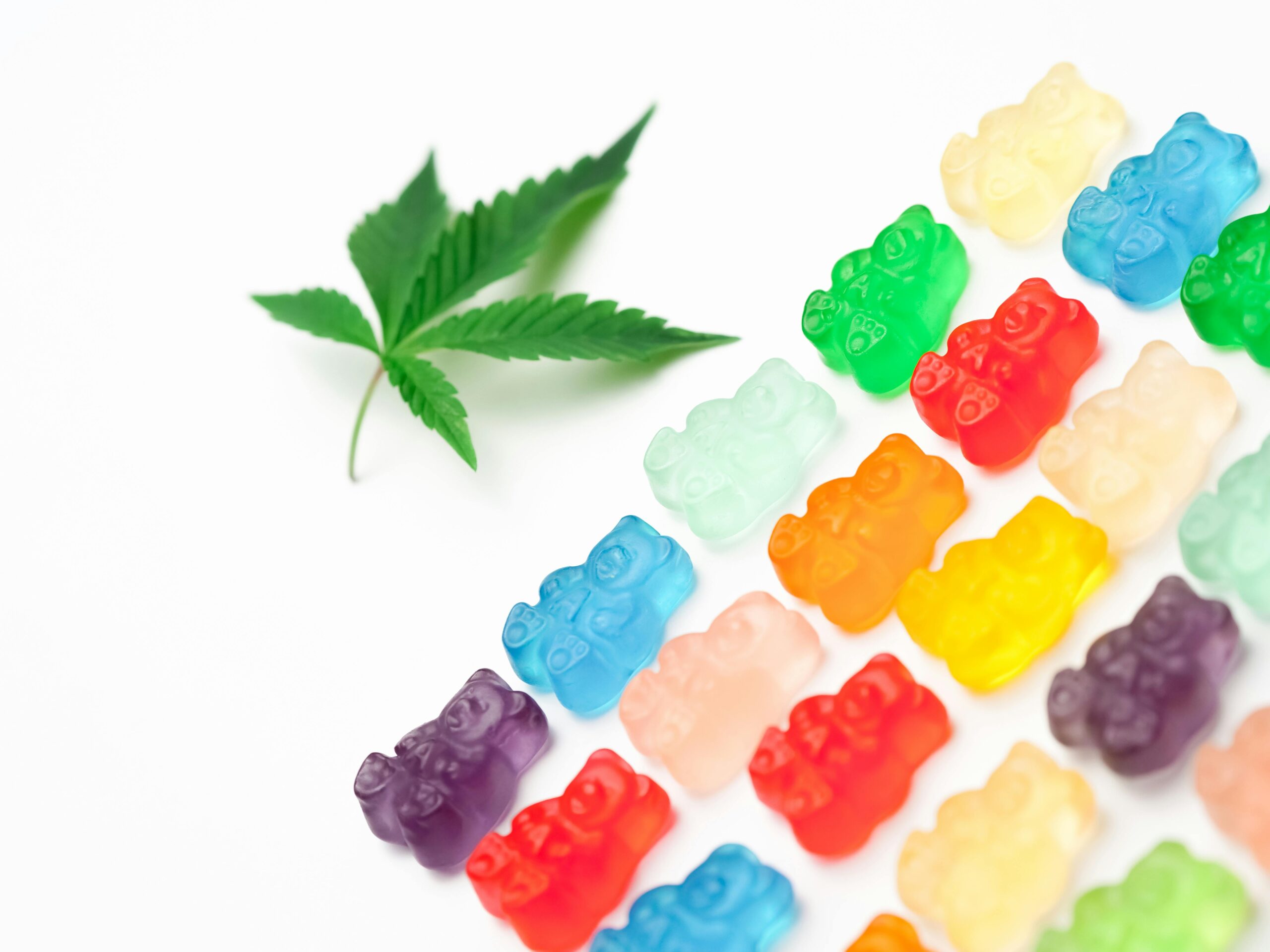 A hemp leaf and gummy bears indicating a hemp or thc-derived product.