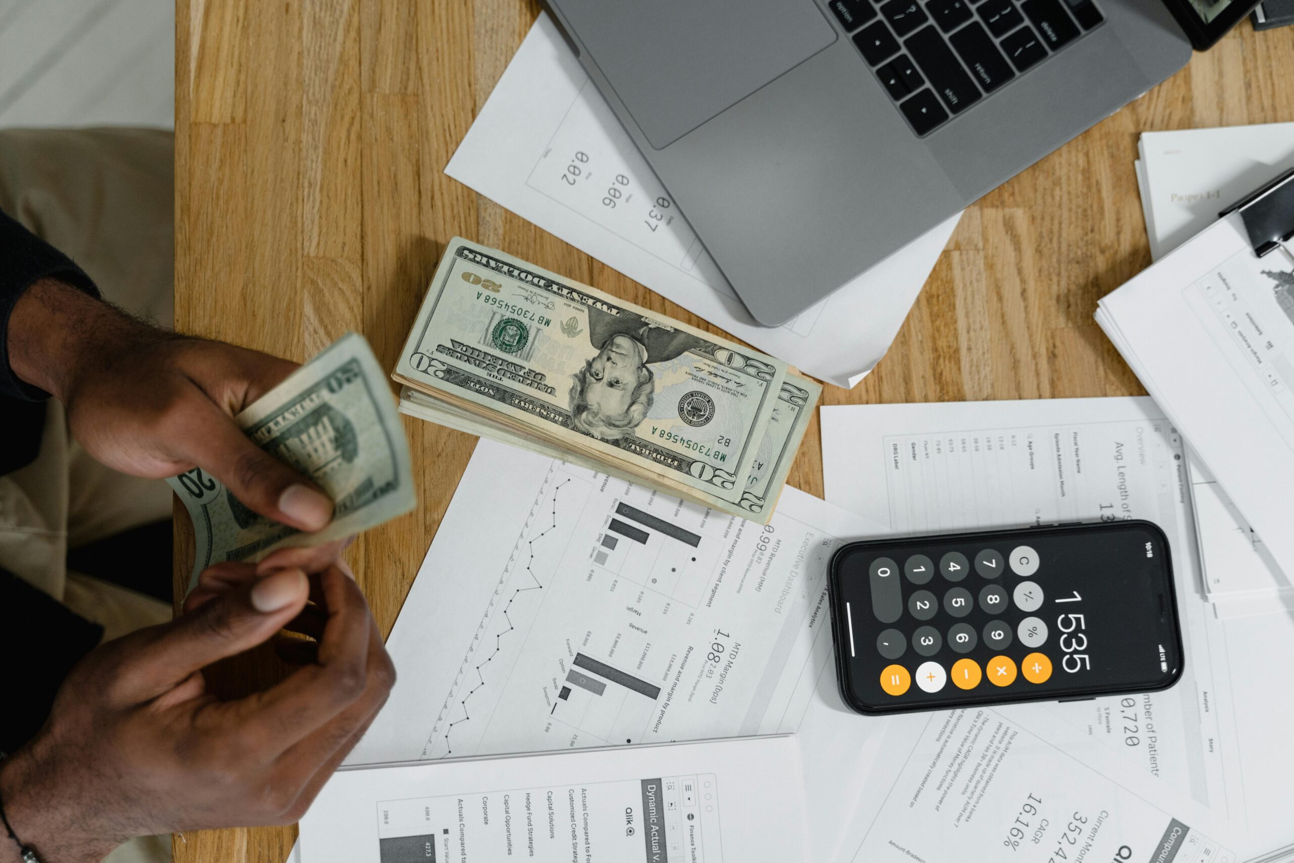 Money and planning documents sit on a table.