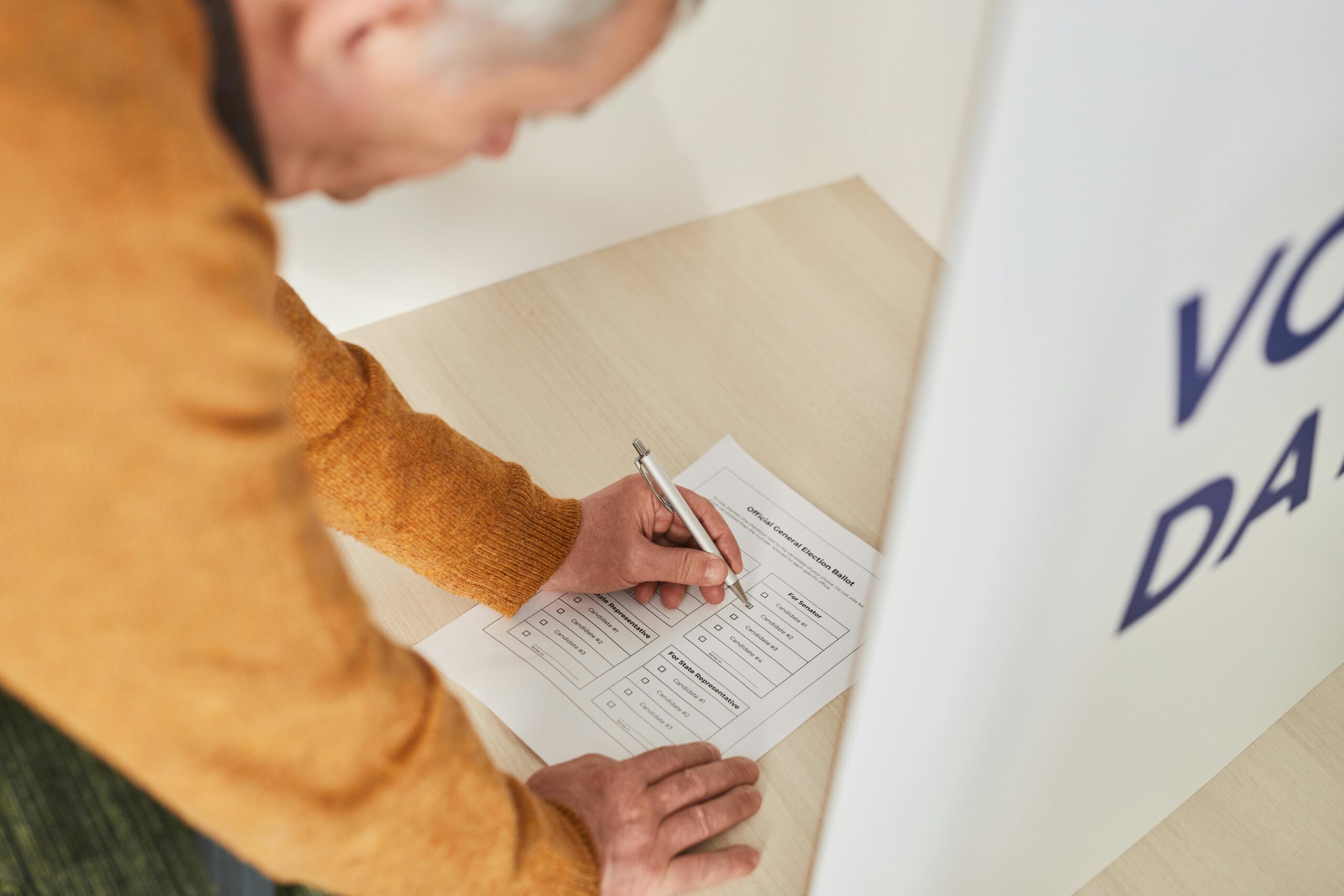 A person fills out a bond election ballot.