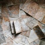 A series of maps sprawled out on a table from above.