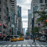A New York intersection with cars, bikes and pedestrians.