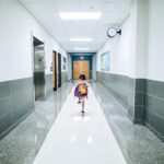 A child runs through a school hallway.