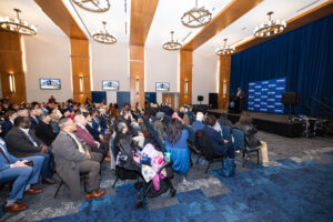 An event room full of people and speakers celebrating the University of North Texas' opening of a new STEM facility.