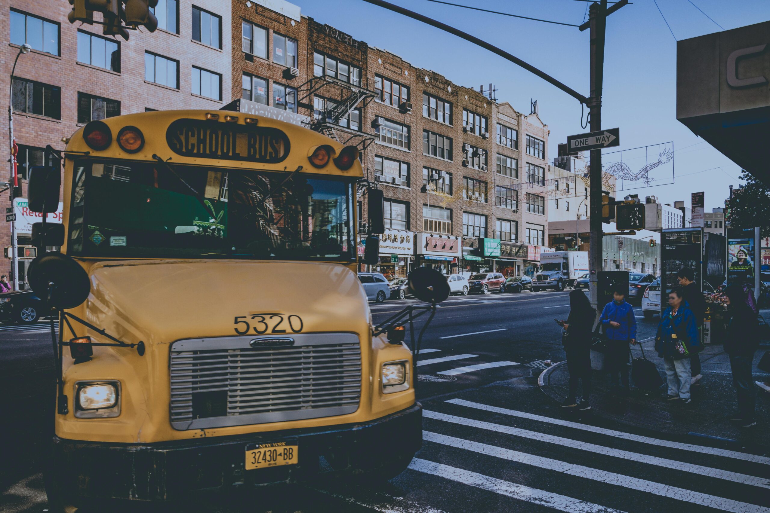 new-york-childcare-construction A yellow school bus along a busy street in New York City.