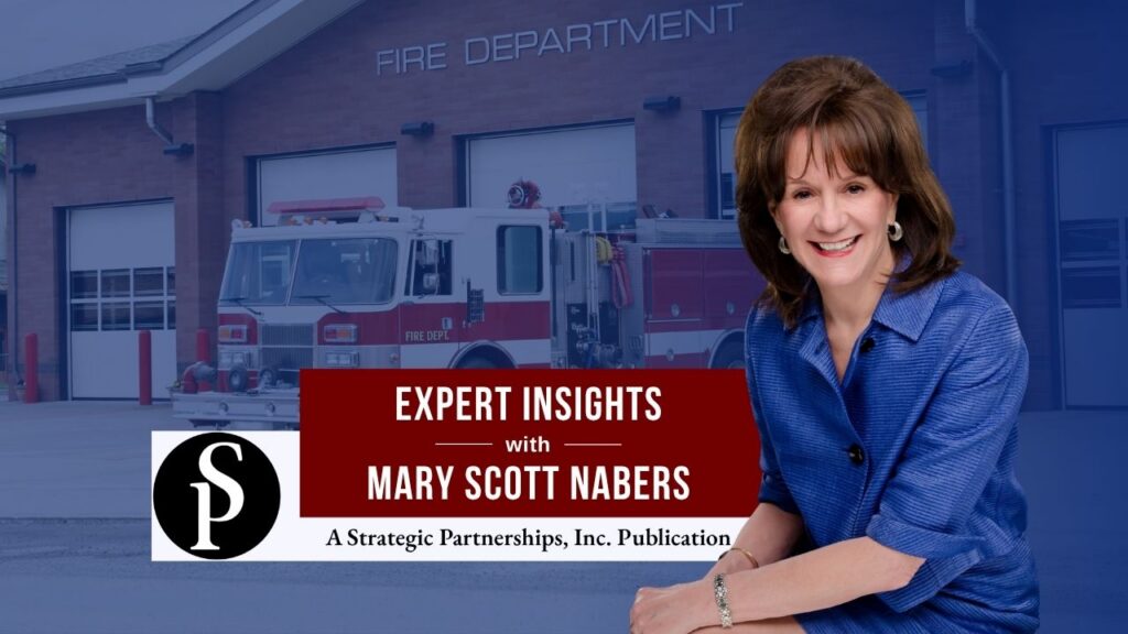Mary Scott Nabers before a fire truck and station for her weekly column.